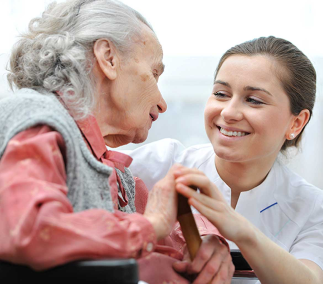 Image of a nurse embracing an elderly woman